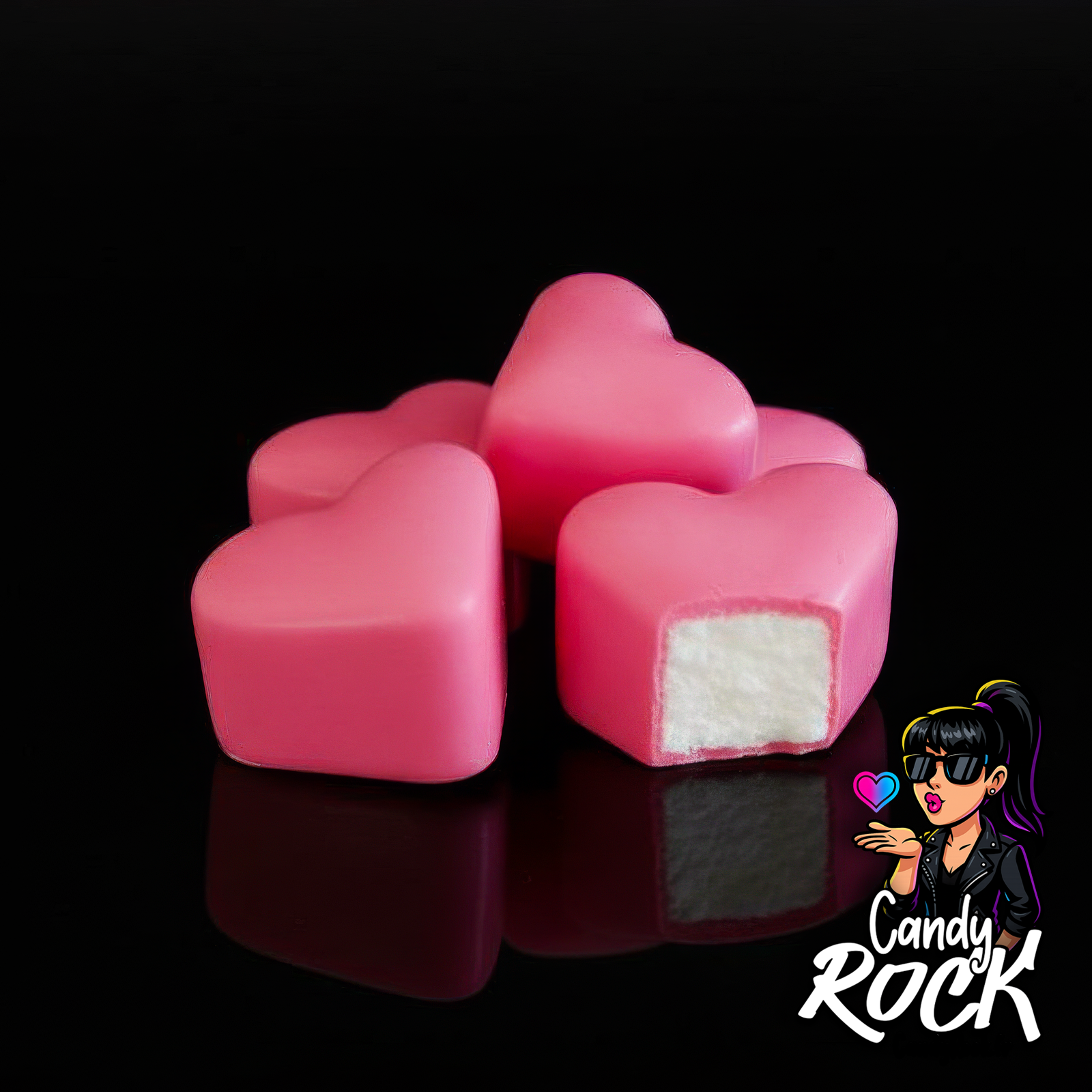 Gros plan sur des guimauves cœur roses à enrobage fondant, montrant la coupe moelleuse intérieure, CandyRock.