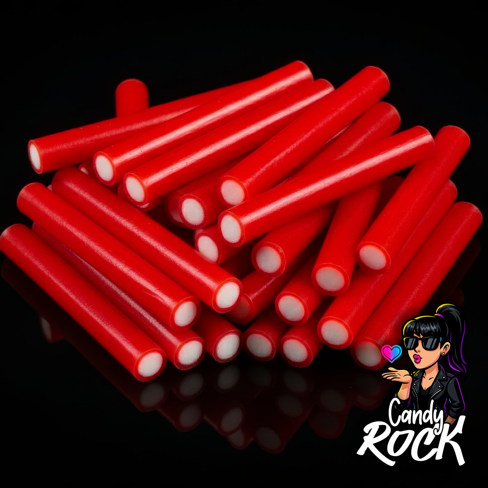 Jumbo sticks rouges lisses au cœur blanc, empilés sur fond noir brillant, rendu gourmand CandyRock.